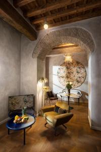 a living room with a couch and a table at Palm Suites - Small Luxury Hotels of the World in Rome