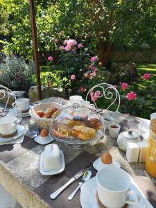 uma mesa com pequeno-almoço de bolos e ovos em Le Mas des Agapes em Beaucaire