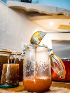 a jar of honey sitting on a counter top at Le Mas des Agapes in Beaucaire