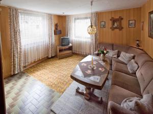 a living room with a couch and a table at Zeiler Peter und Luisie in Waging am See