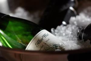 a bottle of wine in a pot of snow at Hotel Alter Wirt in Hallbergmoos
