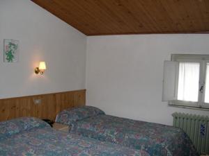 Postel nebo postele na pokoji v ubytování Albergo Le Rose