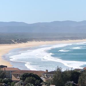 a view of a beach with buildings and the ocean at OCEAN VIEW GUEST HOUSE in Jeffreys Bay