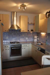 a kitchen with white cabinets and a stove top oven at Ferienwohnung Mattle in Jerzens