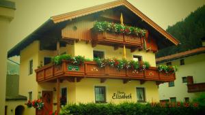 a building with flower boxes and balconies on it at Haus Elisabeth in Tux