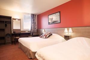 a hotel room with two beds with red walls at Ace Hotel Noyelles in Noyelles-Godault