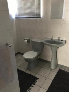 a bathroom with a toilet and a sink at Tortilla no 3 in Bloemfontein