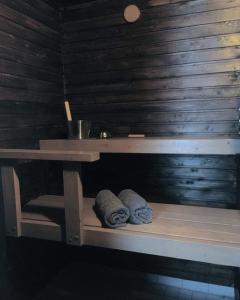 a wooden table with two towels sitting under a table at Arcticson / pohjosen poika in Syöte