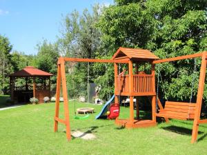 a playground with a slide and a swing set at Willa Sokołówka in Polanica-Zdrój