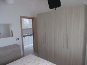 a bedroom with a large wooden cabinet with a television on it at Bilo Francesca e Massimo in Castelnuovo Magra