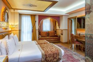 a bedroom with a large bed and a large window at Hotel Sultania Boutique Class in Istanbul