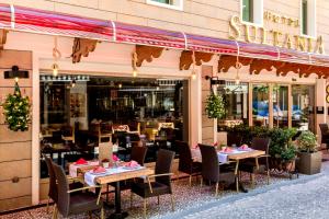 a restaurant with tables, chairs and umbrellas at Hotel Sultania Boutique Class in Istanbul