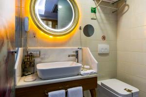 a bathroom with a sink, toilet and bathtub at Hotel Sultania Boutique Class in Istanbul