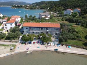 an aerial view of a building with people on a beach at Aparthouse Penelope in Supetarska Draga