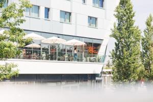 a woman standing on the balcony of a building at harry's home hotel & apartments in Munich