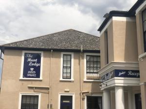 a building with a sign on the front of it at The Hunt Lodge in Leighton Buzzard