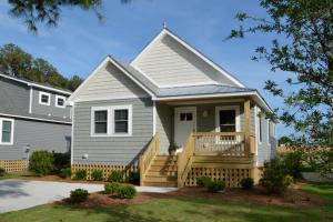 a small house with a porch and a deck at Kilmarlic Nicklaus Cottage in Powells Point