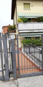 a gate in front of a building with a balcony at Flower House in Verona