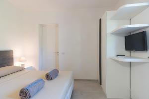 a bedroom with a bed with two blue pillows on it at Nitrodi Thermal Relais in Ischia