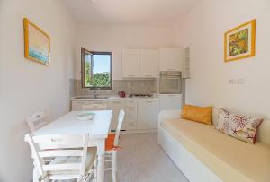 a living room with a white couch and a table at Nitrodi Thermal Relais in Ischia