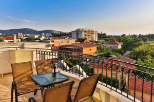 a table and chairs on a balcony with a view at Apolon Apart in Bar, Susanj