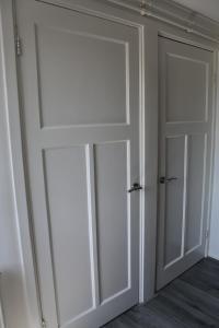 a room with two sliding doors in a room at Sleep Inn Amsterdam in Amsterdam