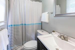 a bathroom with a sink and a toilet and a shower at Luxury Home w/GameRoom KingSizeBed near Six Flags in Austell