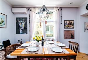 a dining room with a wooden table and chairs at 3BDR The Hadjis - City Center Flat in Sofia