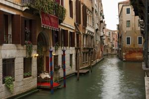 a canal between two buildings in a city at Hotel Becher in Venice
