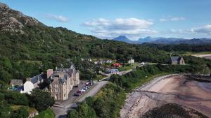 an aerial view of a building on a hill next to a road at Gairloch Hotel 'A Bespoke Hotel' in Gairloch
