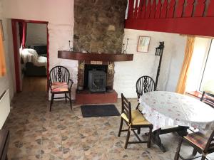 a living room with a table and a fireplace at Johnny Joe's in Achill