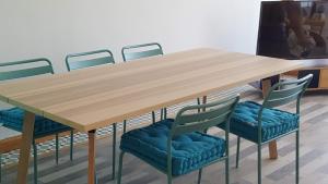 a wooden table with four chairs around it at vinaros playa de arena in Vinarós