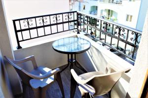 a balcony with a glass table and two chairs at Martinović Rooms in Budva