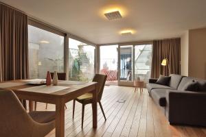 a living room with a table and a couch at L'Aparté in Nancy