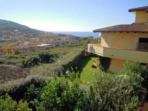 a view of a house with a view of the ocean at Attico La Murighessa in Castelsardo