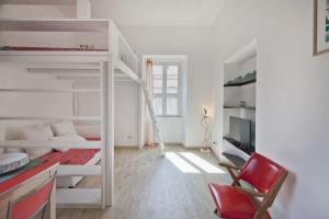 a room with two bunk beds and a red chair at Colosseum relax family apartament in Rome