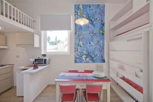 a kitchen with a table and two red chairs at Colosseum relax family apartament in Rome