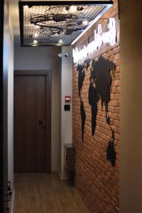 a brick wall with a map of the world on it at Q Luxury Rooms in Thessaloniki