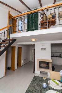 a living room with a staircase and a fireplace at Apartment Sun view in Mali Lošinj