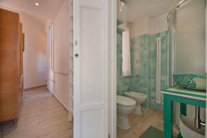 a bathroom with a toilet and a sink and a shower at Colosseum relax family apartament in Rome