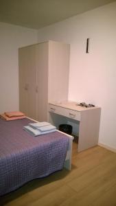 a small room with a bed and a desk at Sot la Mont in Cividale del Friuli