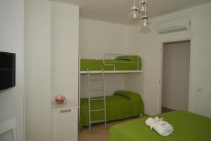 ein Schlafzimmer mit einem grünen Etagenbett mit einer Leiter in der Unterkunft Ica house in Castellammare di Stabia