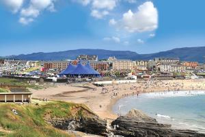 a group of people on a beach near the water at 37 Atlantic Point, Ground Floor, Sea View Apartment sleeps 6 in Bundoran