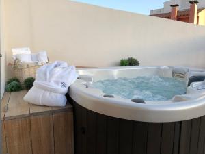 a bathtub with a towel on top of it at Sa Voga Hotel & Spa in Arenys de Mar