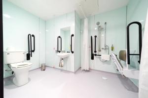 a bathroom with a toilet and a sink at easyHotel London City Shoreditch in London
