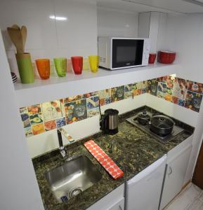 a kitchen counter with a sink and a microwave at Departamento Céntrico con Vista in San Carlos de Bariloche