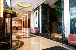 a lobby of a hotel with black marble walls at Riu Plaza España in Madrid