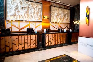 a lobby of a hotel with statues on the wall at Riu Plaza España in Madrid