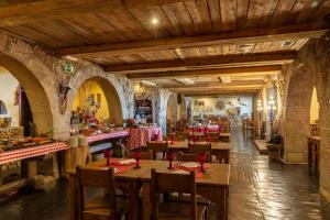 a restaurant with wooden tables and chairs in a building at Luna Hotel Serra da Estrela in Covilhã