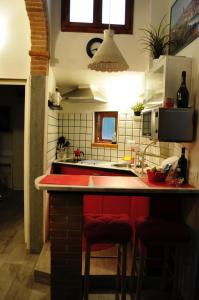 a kitchen with a red island in a kitchen at Conte Canacci in Florence